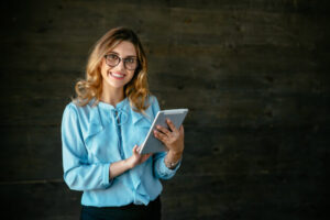 happy beautiful young business woman standing with tablet widely smiling_8353 6766