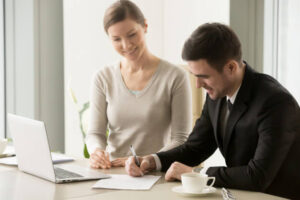 female male business leaders signing contract_1163 5368